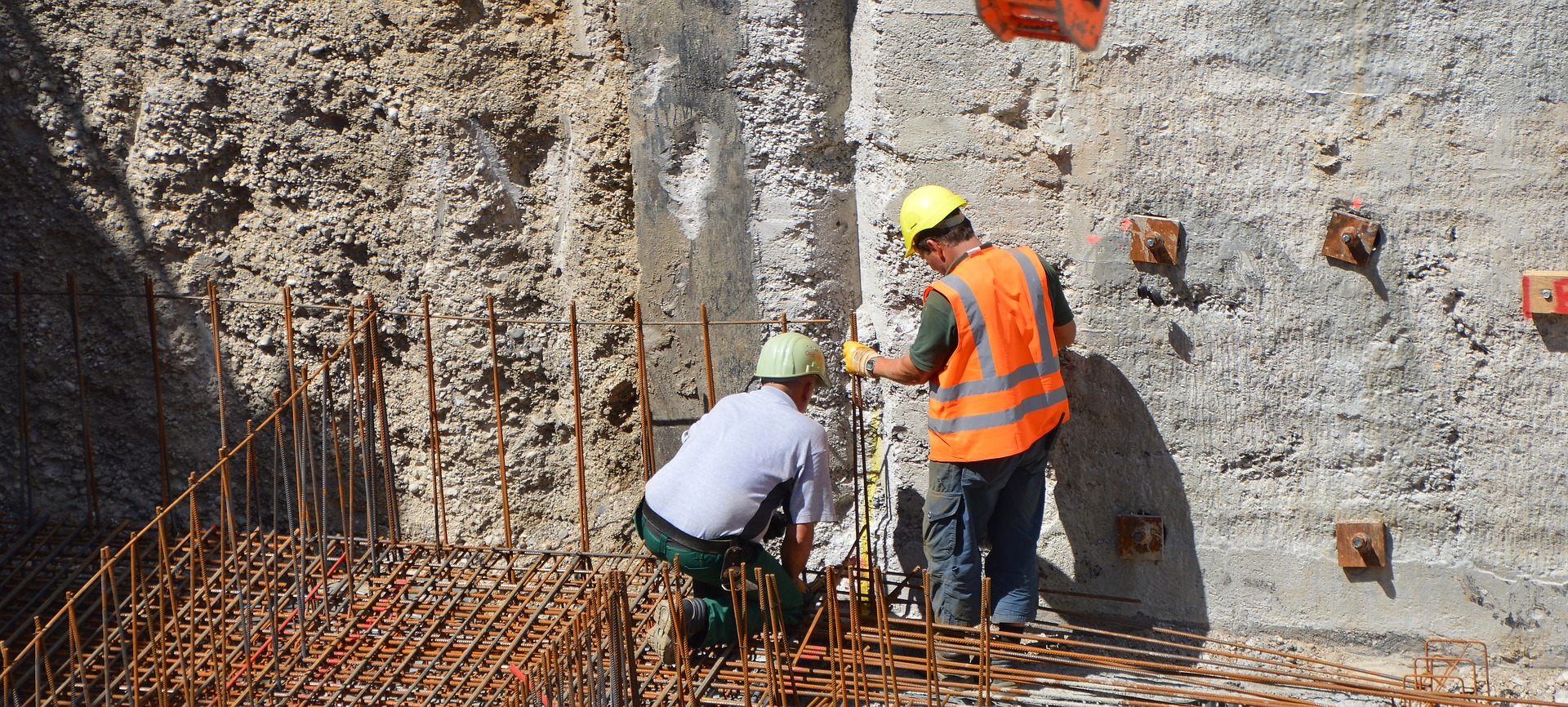Construction workers working on building foundation underpinning